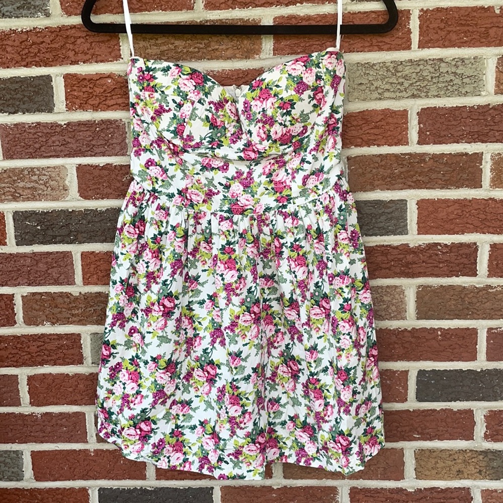 White strapless dress with pink, green, and purple floral. Size is a medium.